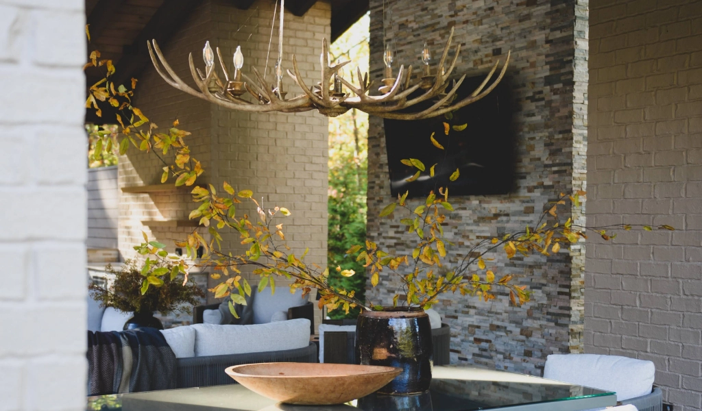 A dining room with antlers suspended from the ceiling.