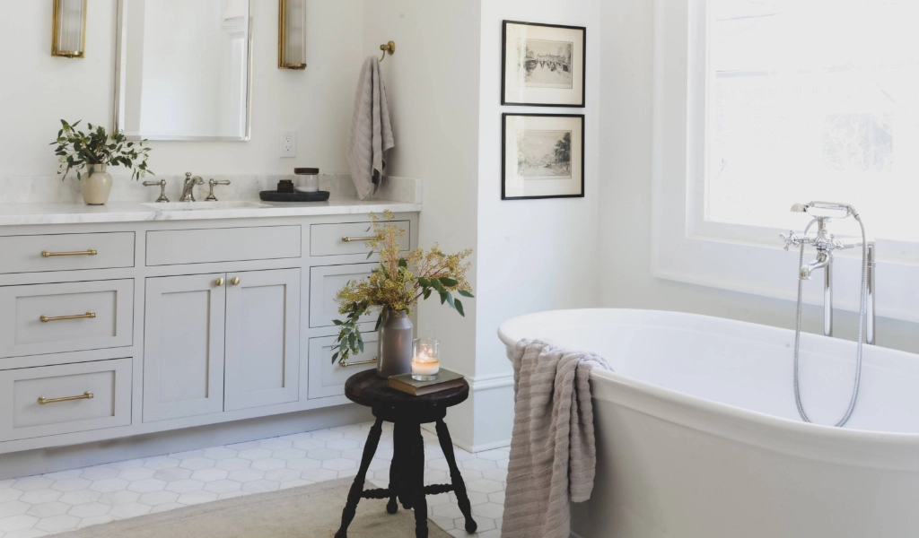 A white and gray bathroom with a white tub.