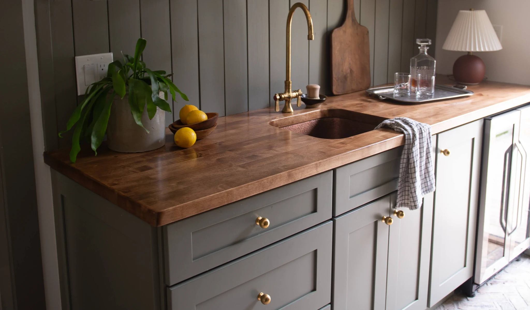 A kitchen with a wooden counter top built by custom home builders.