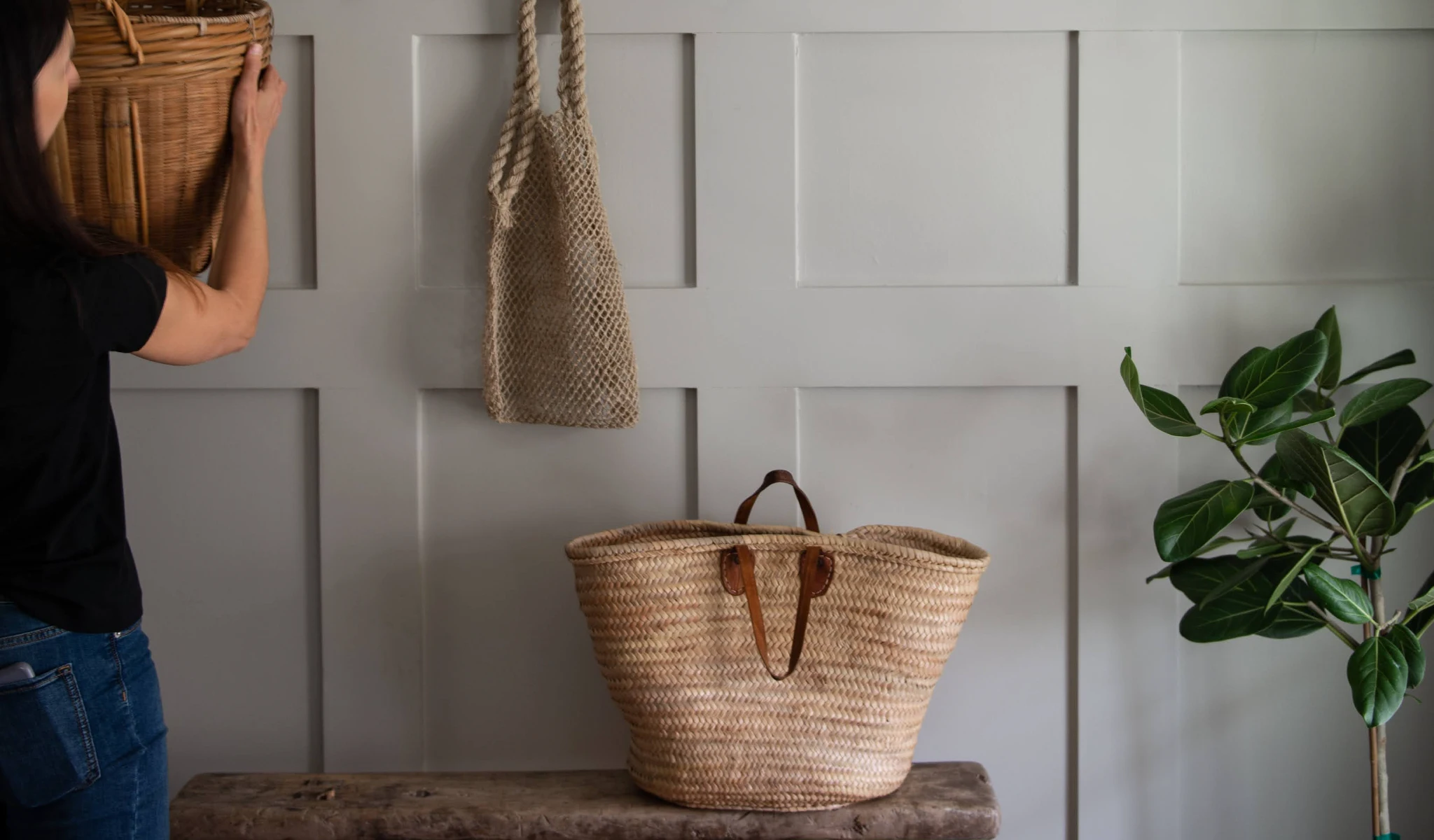 Two wicker baskets hanging on a wall.