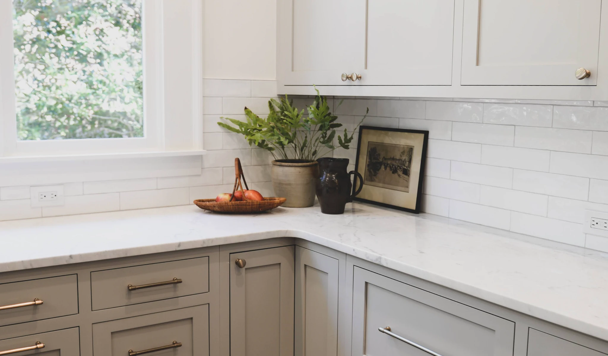 A white kitchen with gray cabinets in a new home construction.