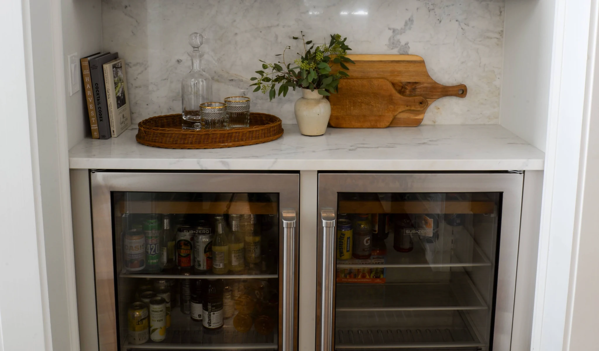 A refrigerator with a glass door, showcasing beverages.