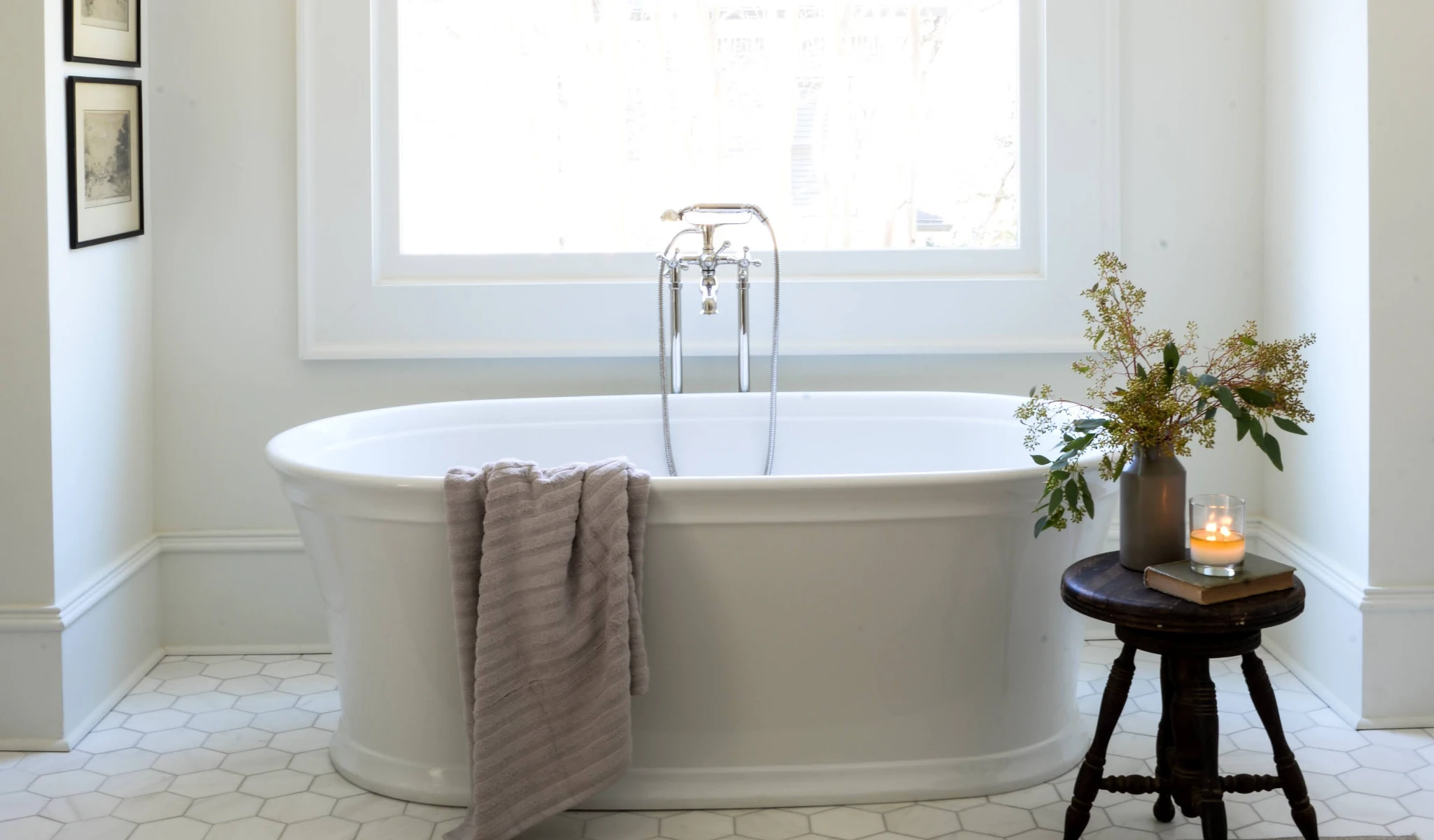 A white bathtub in a bathroom with a window, perfect for new home construction.