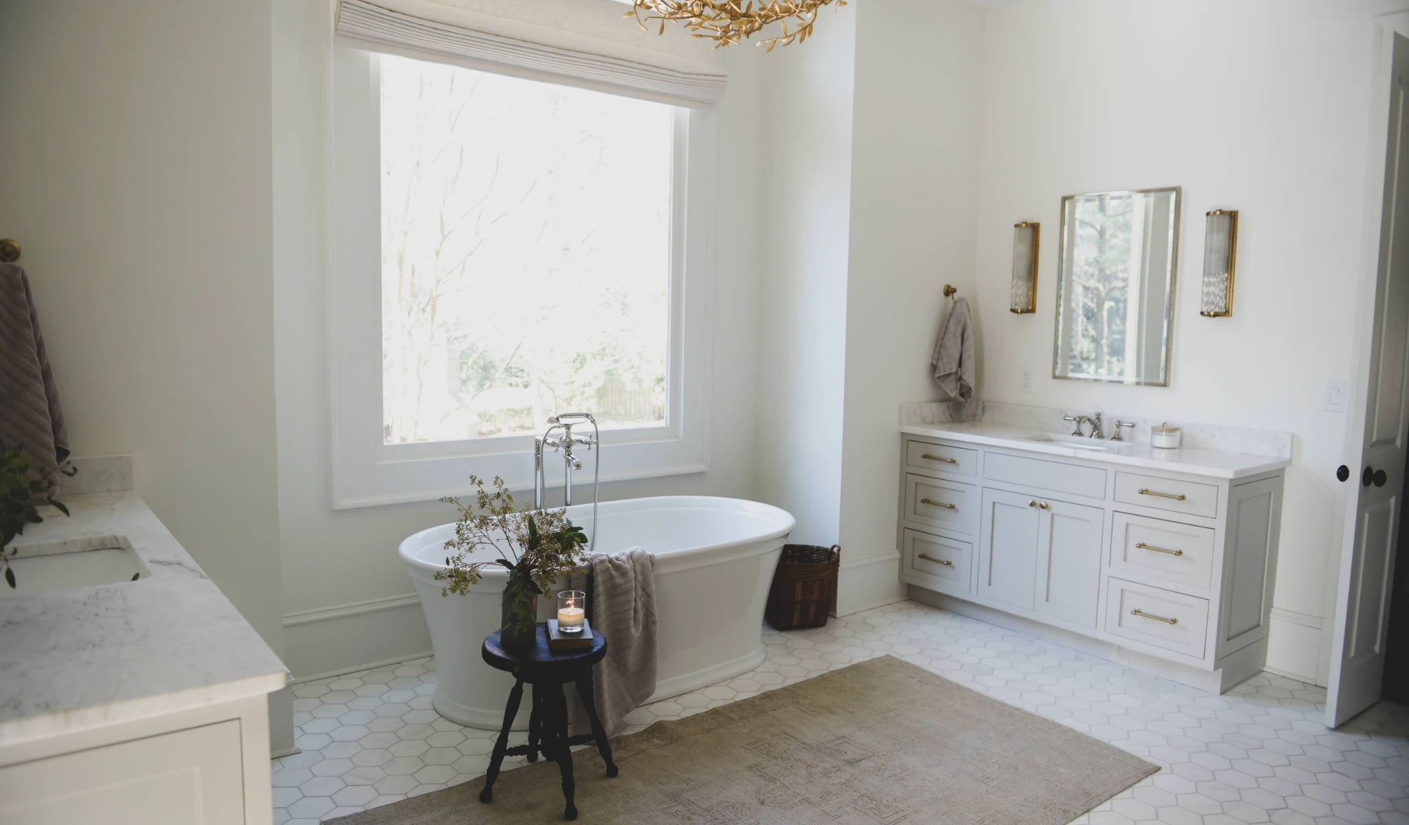 A white bathroom with a chandelier.