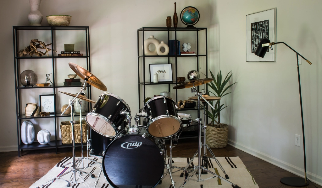 A drum set is placed on a rug in a room.