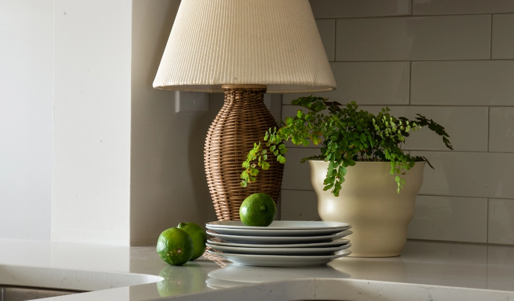 A lamp on a counter in a kitchen designed by a custom home builder.