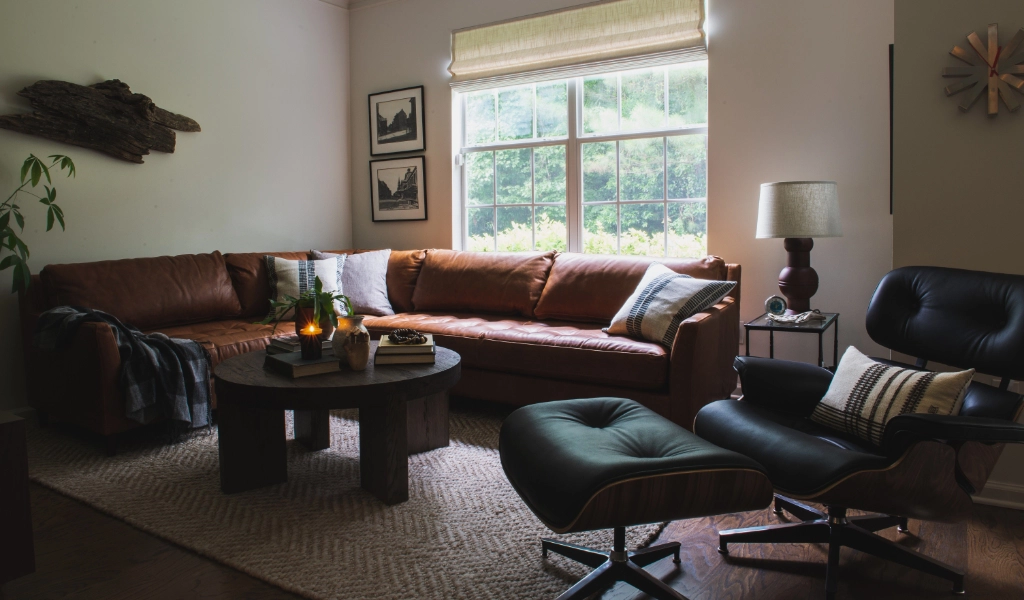 A living room with brown leather furniture and a coffee table.