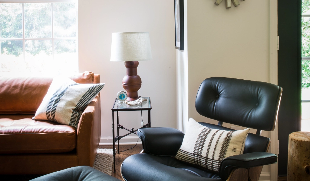A living room featuring a leather chair and ottoman.