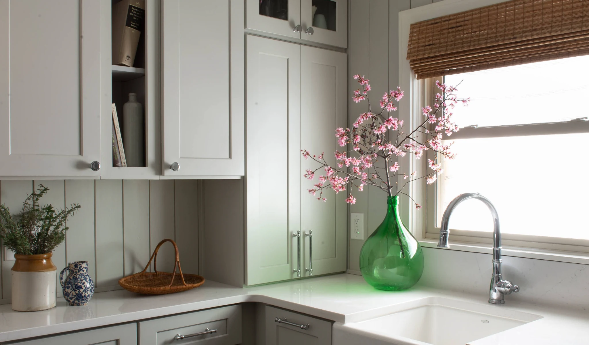 A kitchen with a new sink and window.