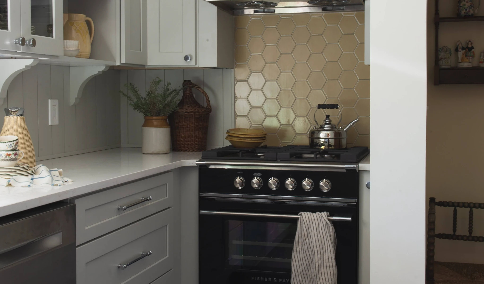 A small kitchen with a stove and oven designed by home builders.