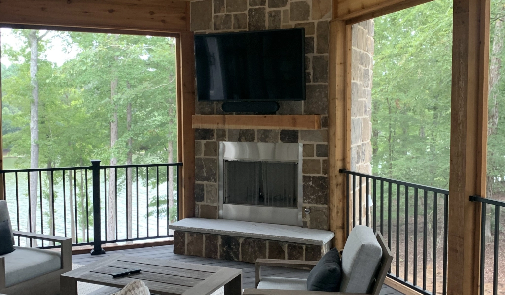 A patio with furniture and a flat screen tv.