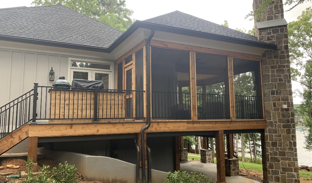 A house with a screened porch and stairs designed by a home designer.