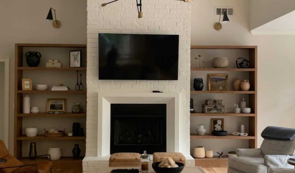A living room with a fireplace and bookshelves.