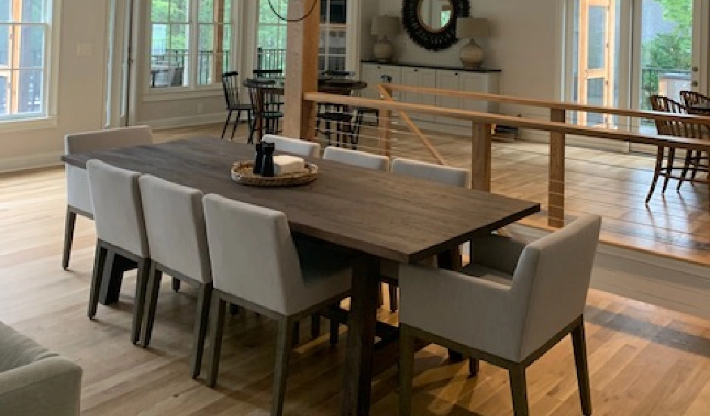 A dining room with a wooden table and chairs.