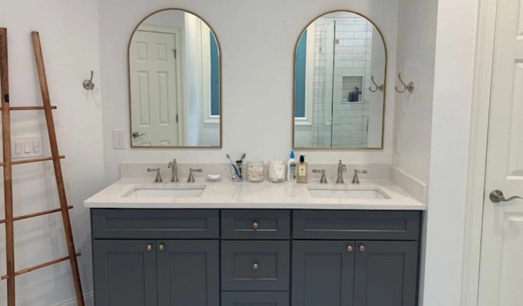 A bathroom with two sinks and two mirrors.
