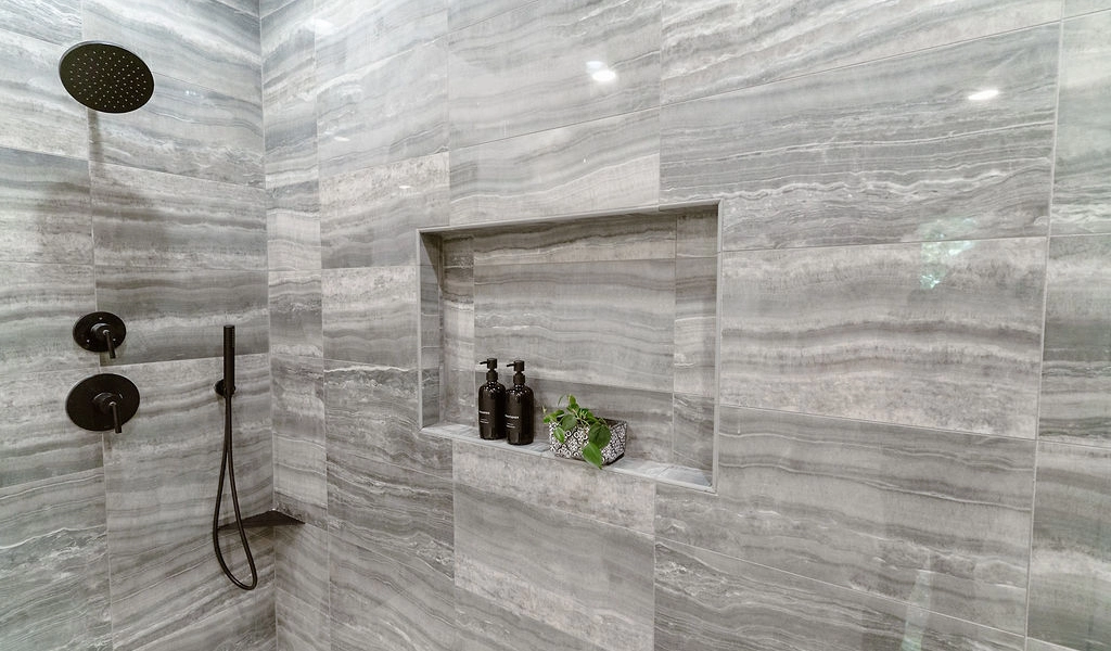 A bathroom with a grey marble shower wall.