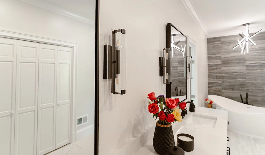 A modern bathroom featuring a white sink and mirror.