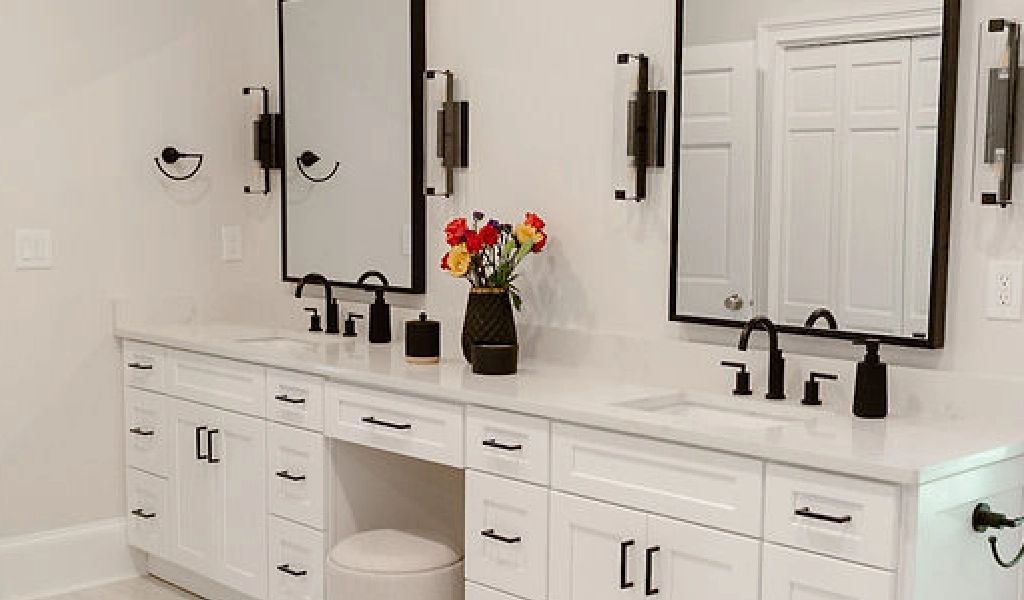 A white bathroom in a new home construction with two sinks and a mirror.
