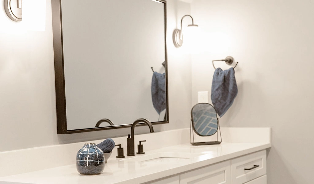 A white bathroom vanity with blue accents.