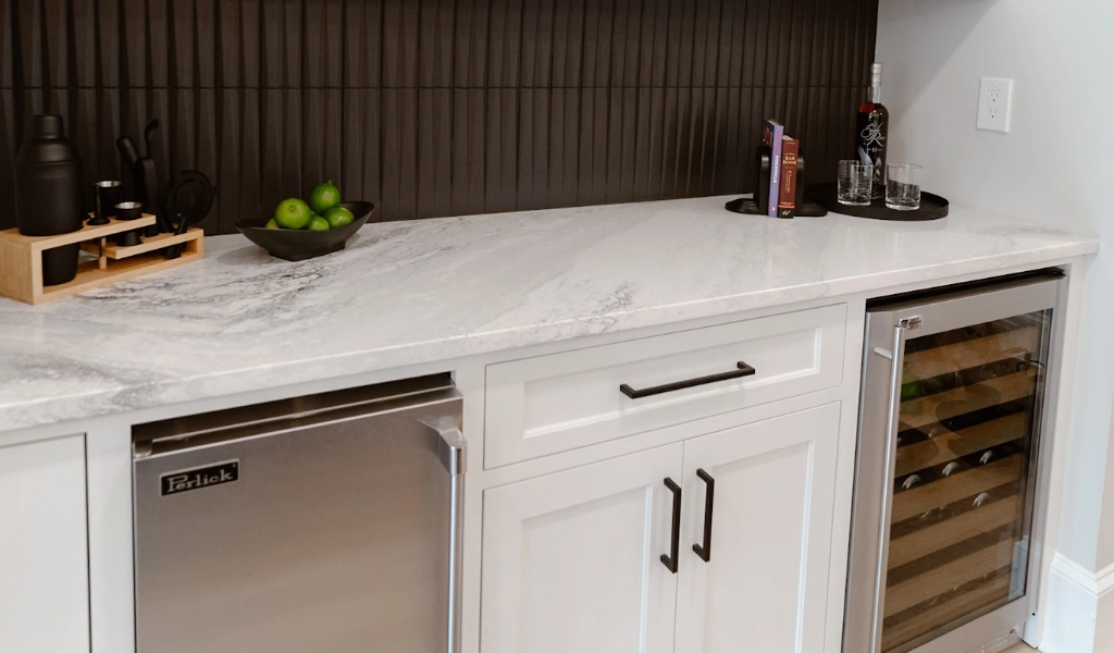 A black and white kitchen with a wine cooler.