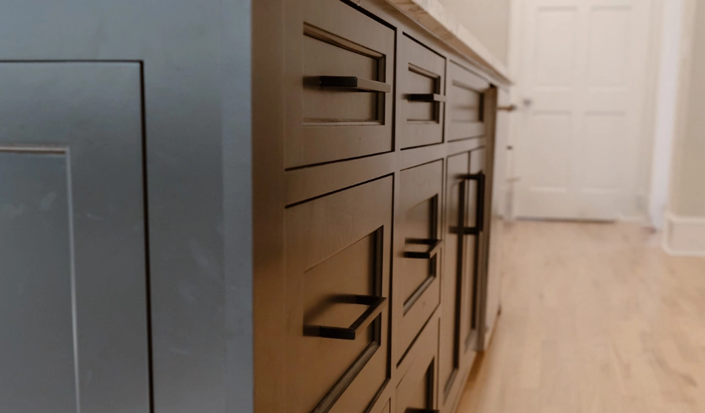 A close up of a kitchen cabinet with drawers.