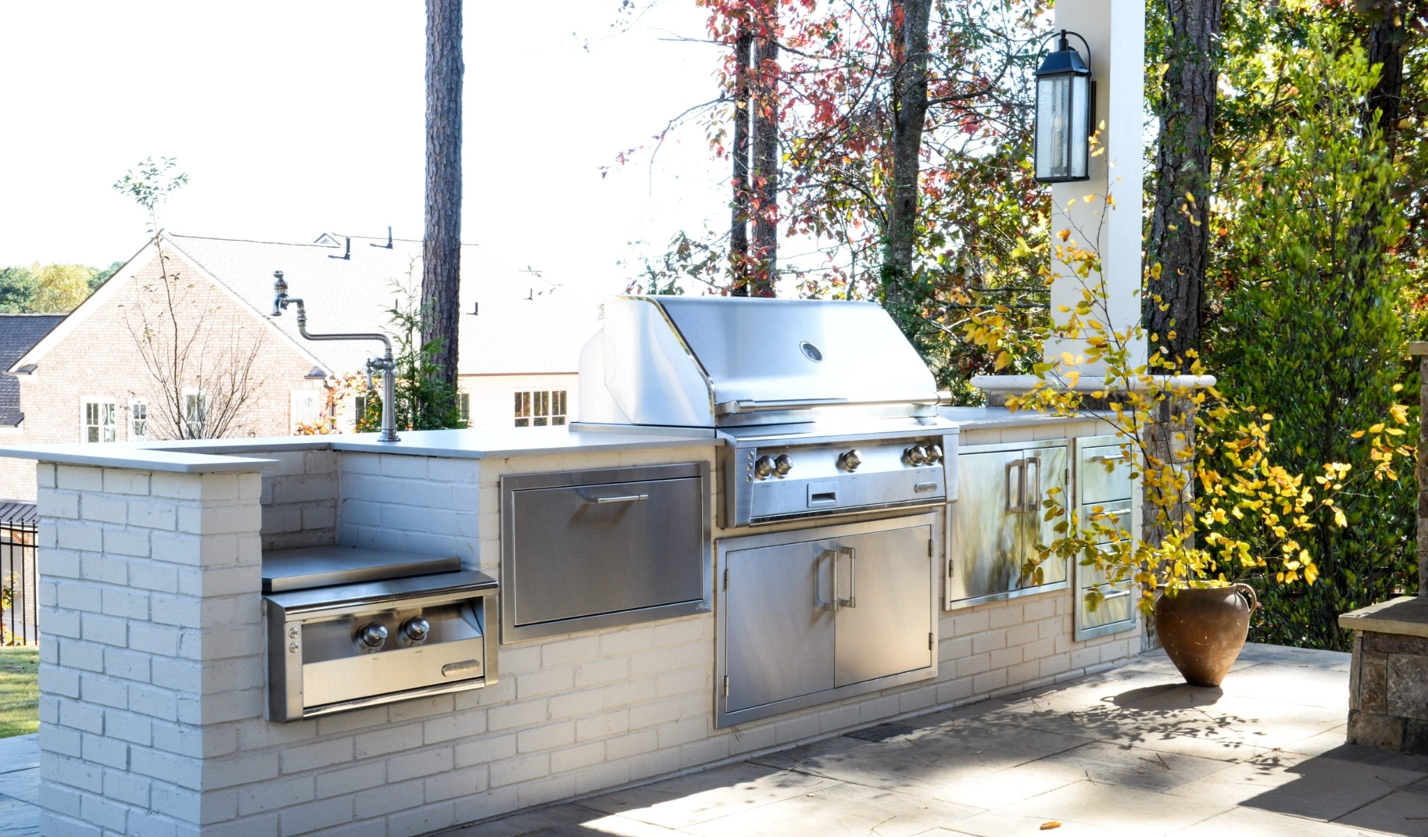 A stainless steel outdoor kitchen with appliances.