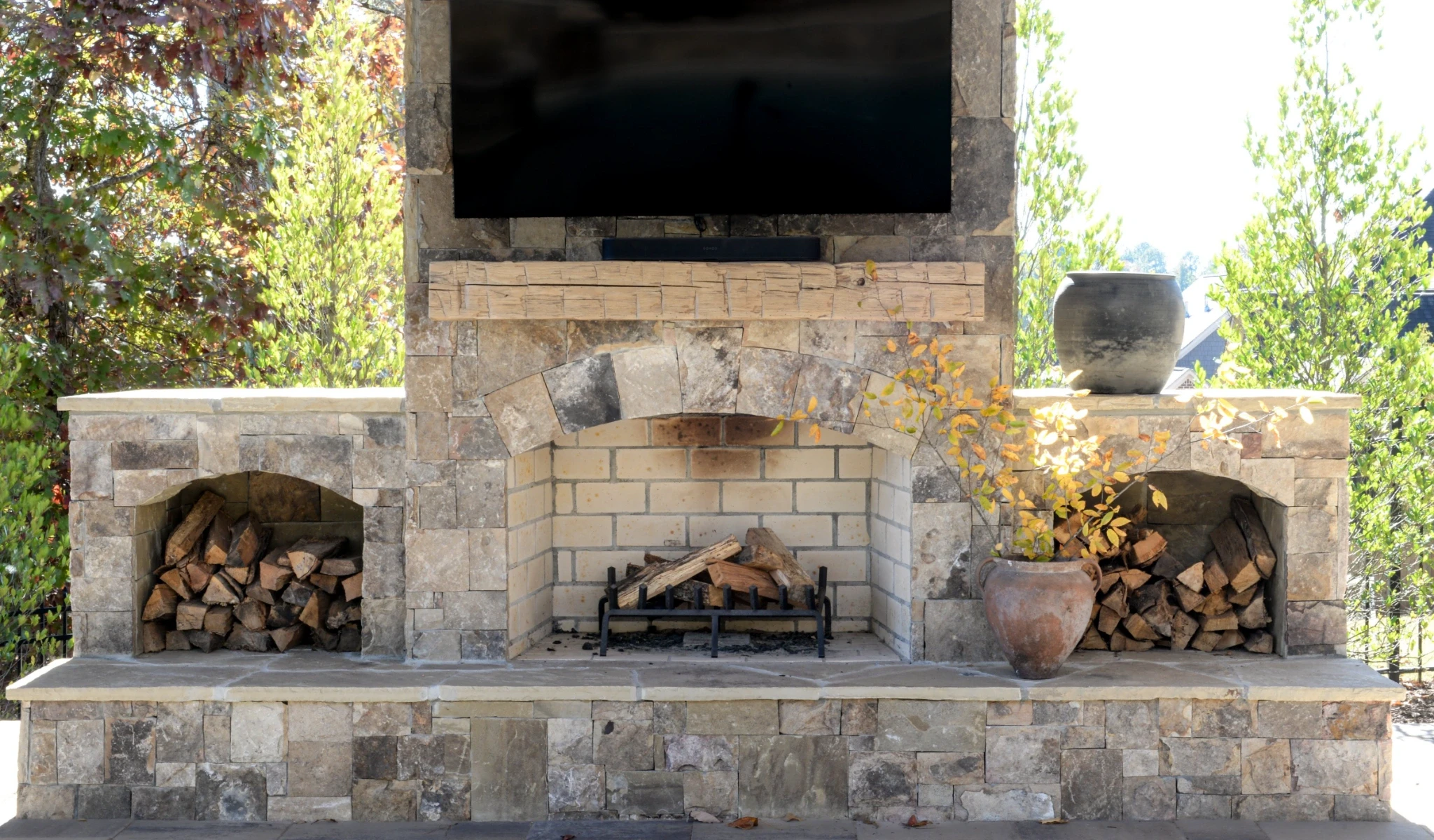 A stone fireplace with a TV mounted above it.