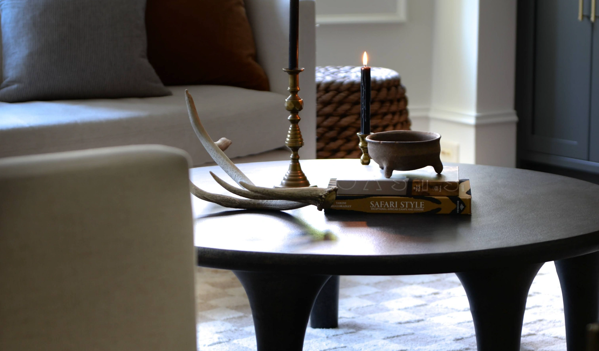 A coffee table adorned with antlers and candles, perfect for cozying up any living space.