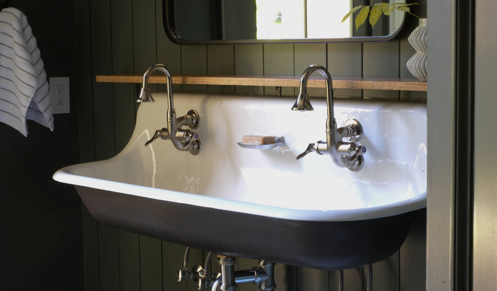 A sink in a bathroom with a mirror above it.