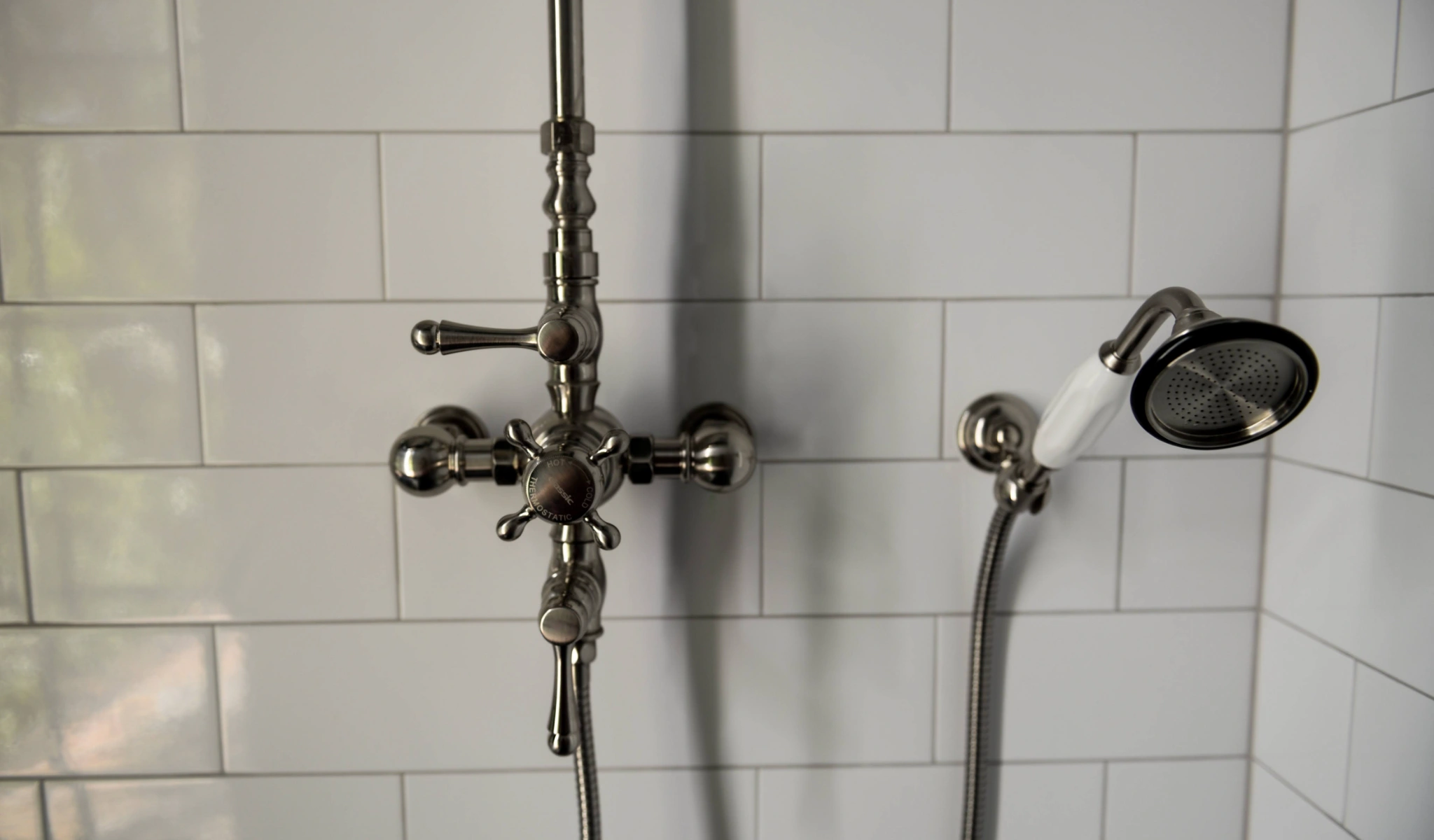 A bathroom with a new shower head in a home remodeling project.