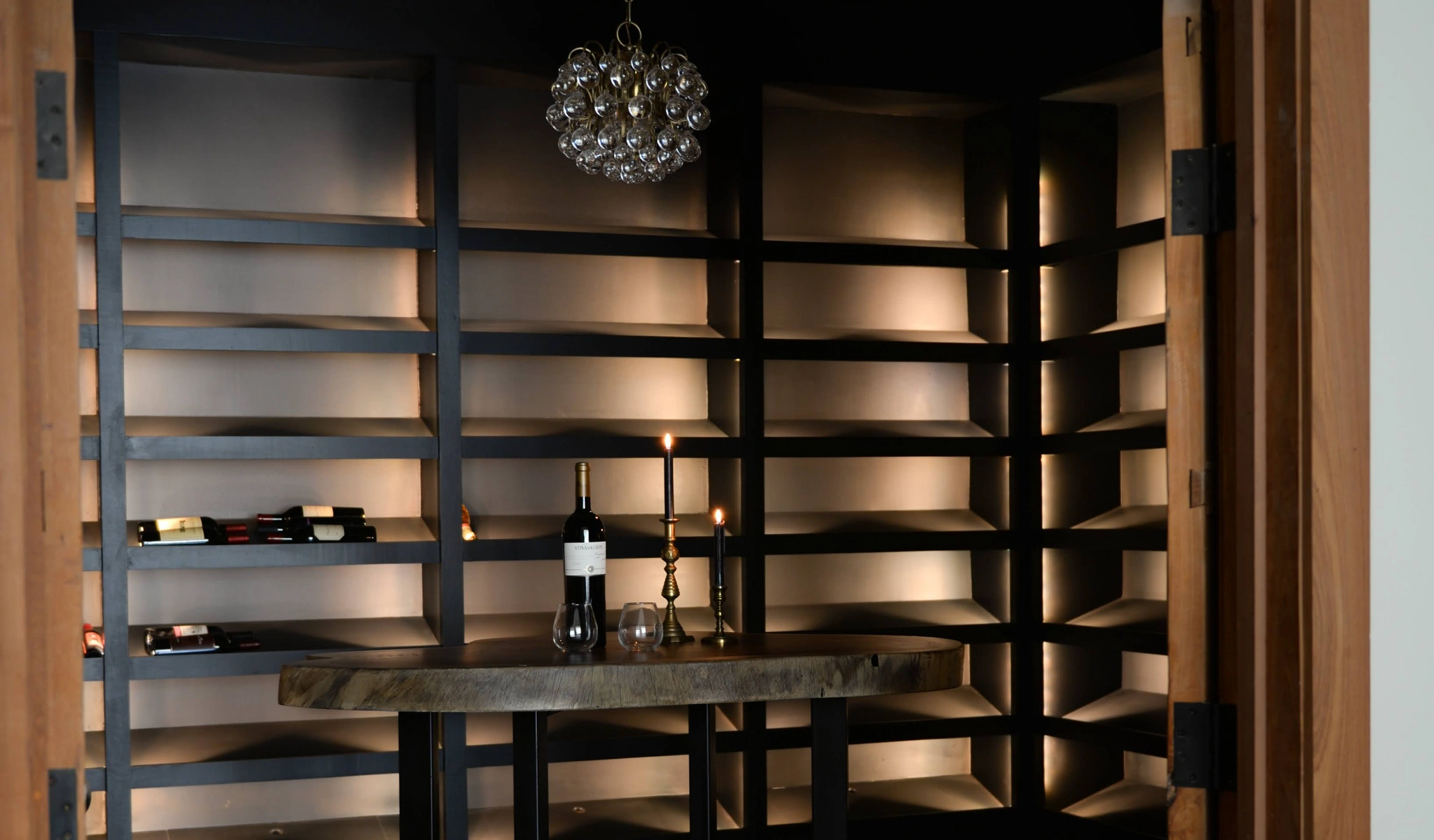 A wine cellar with shelves and a table.
