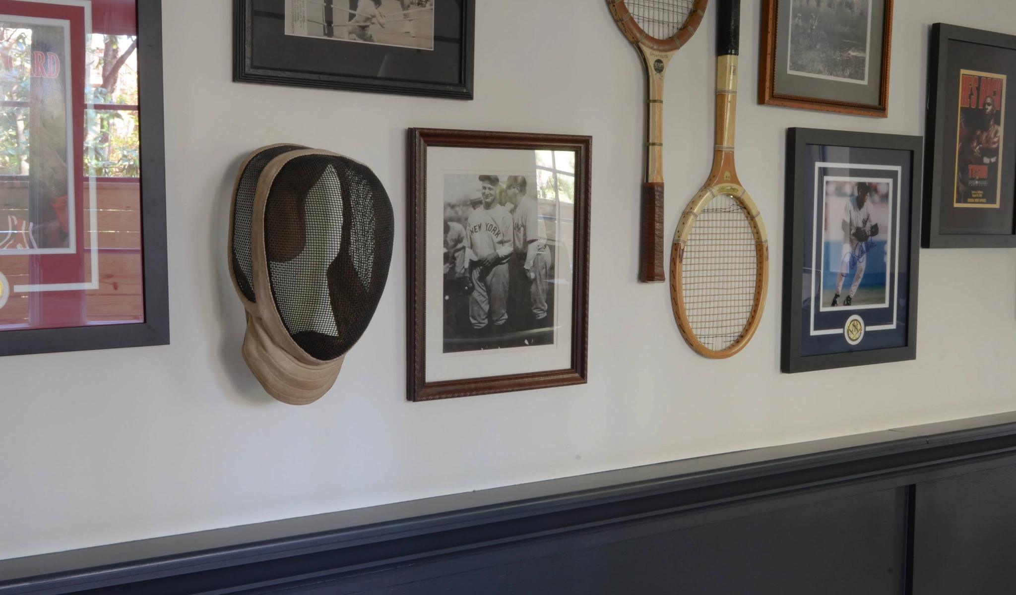 A wall of tennis racquets and other sports memorabilia.