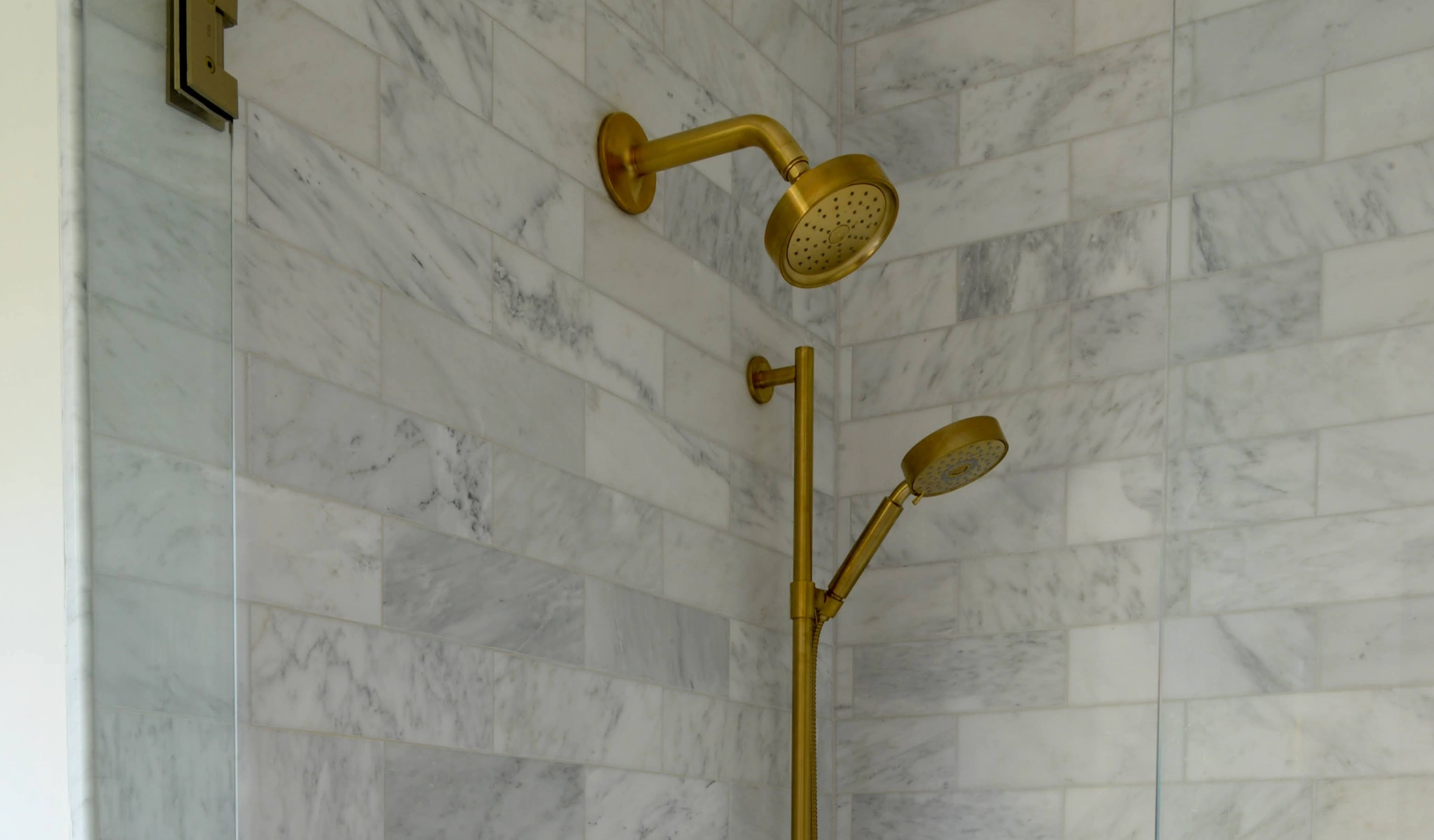 A shower with a luxurious gold shower head.