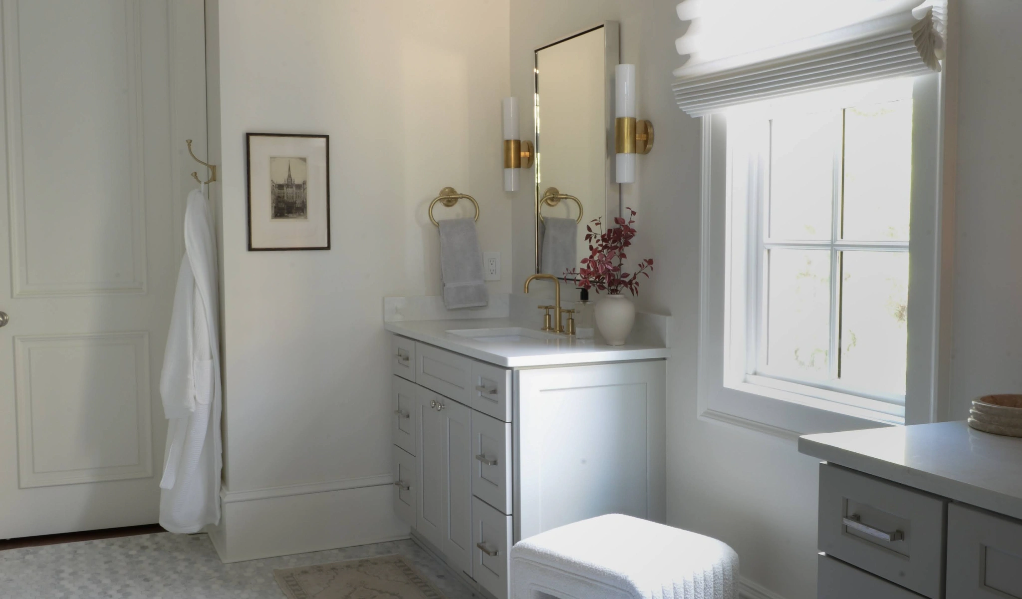 A bathroom with a white vanity and mirror in a new home construction.