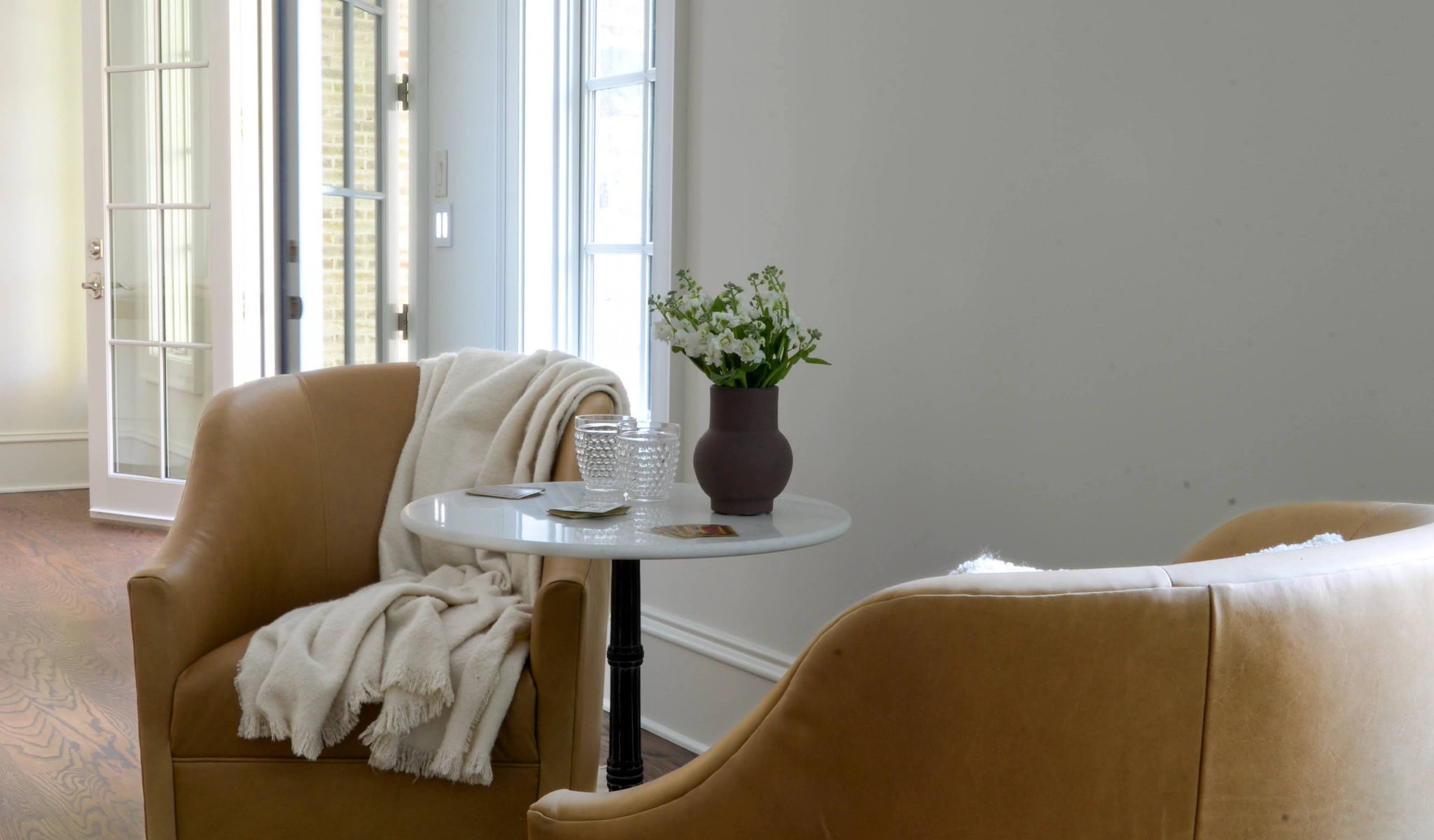 Home remodel with two chairs and a table in the living room.