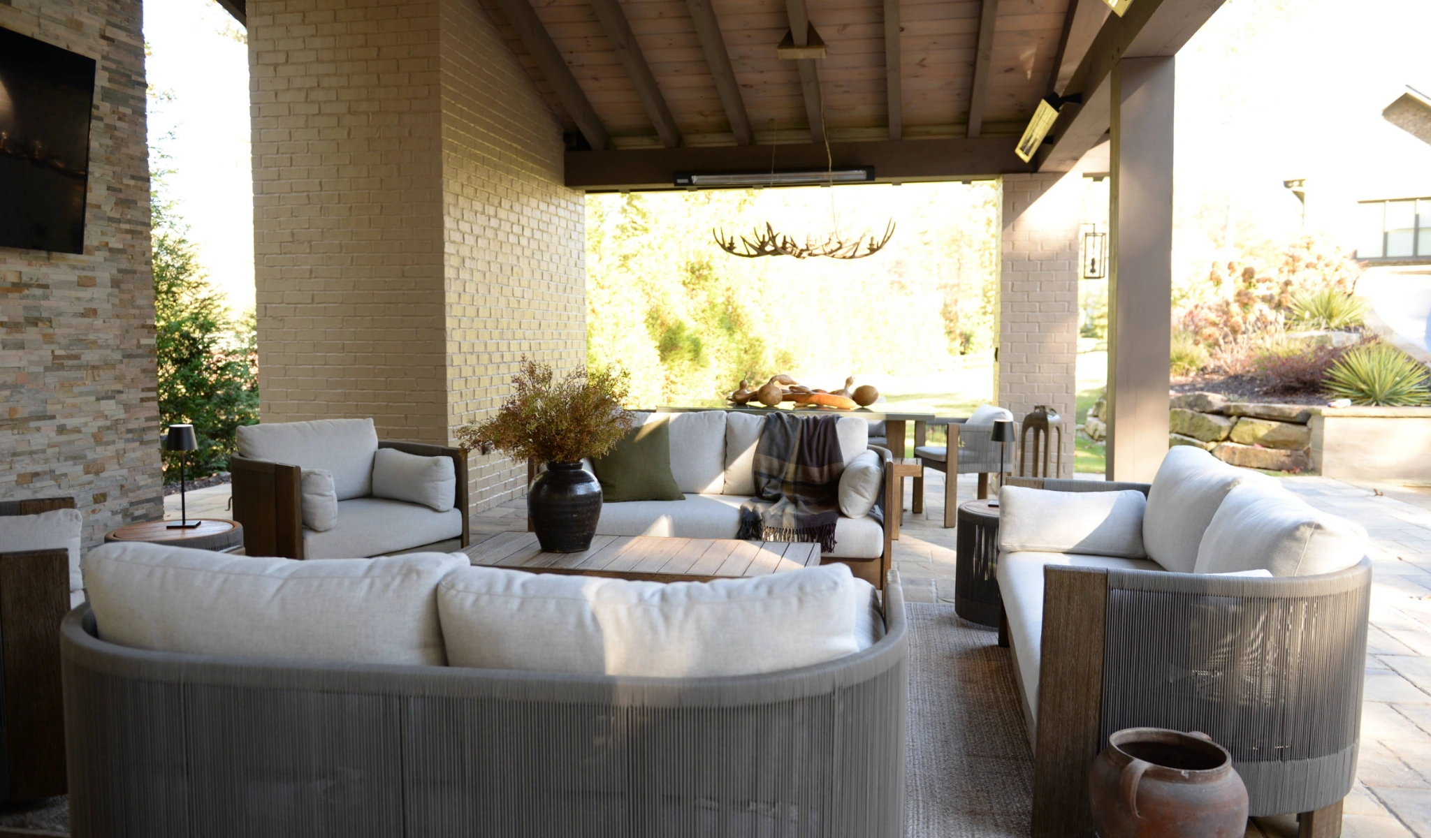 An outdoor living area with furniture and a TV.
