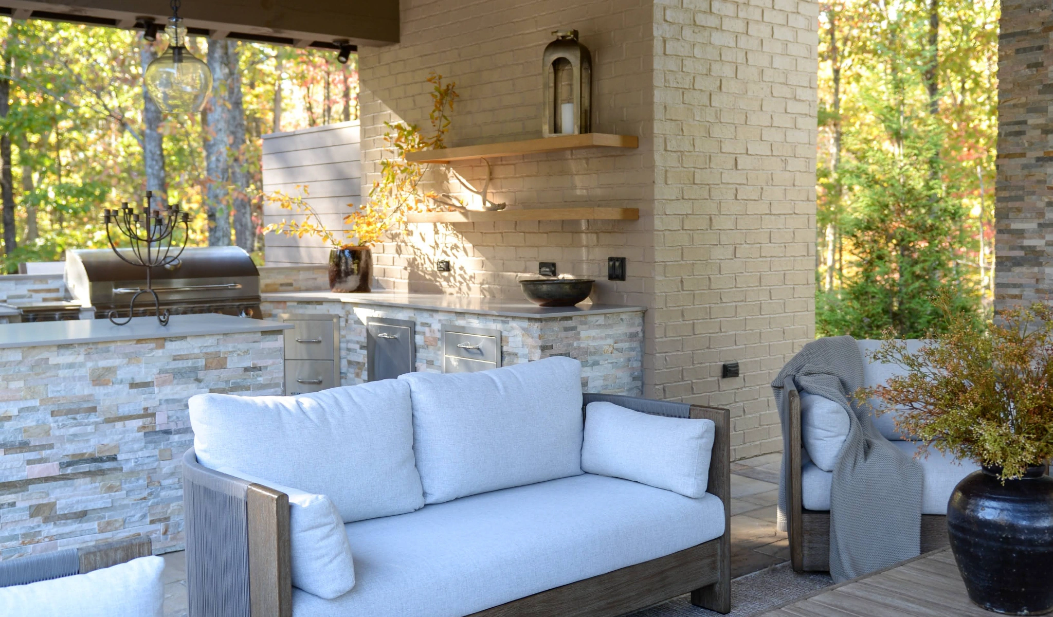 A custom outdoor living area with couches and a grill.