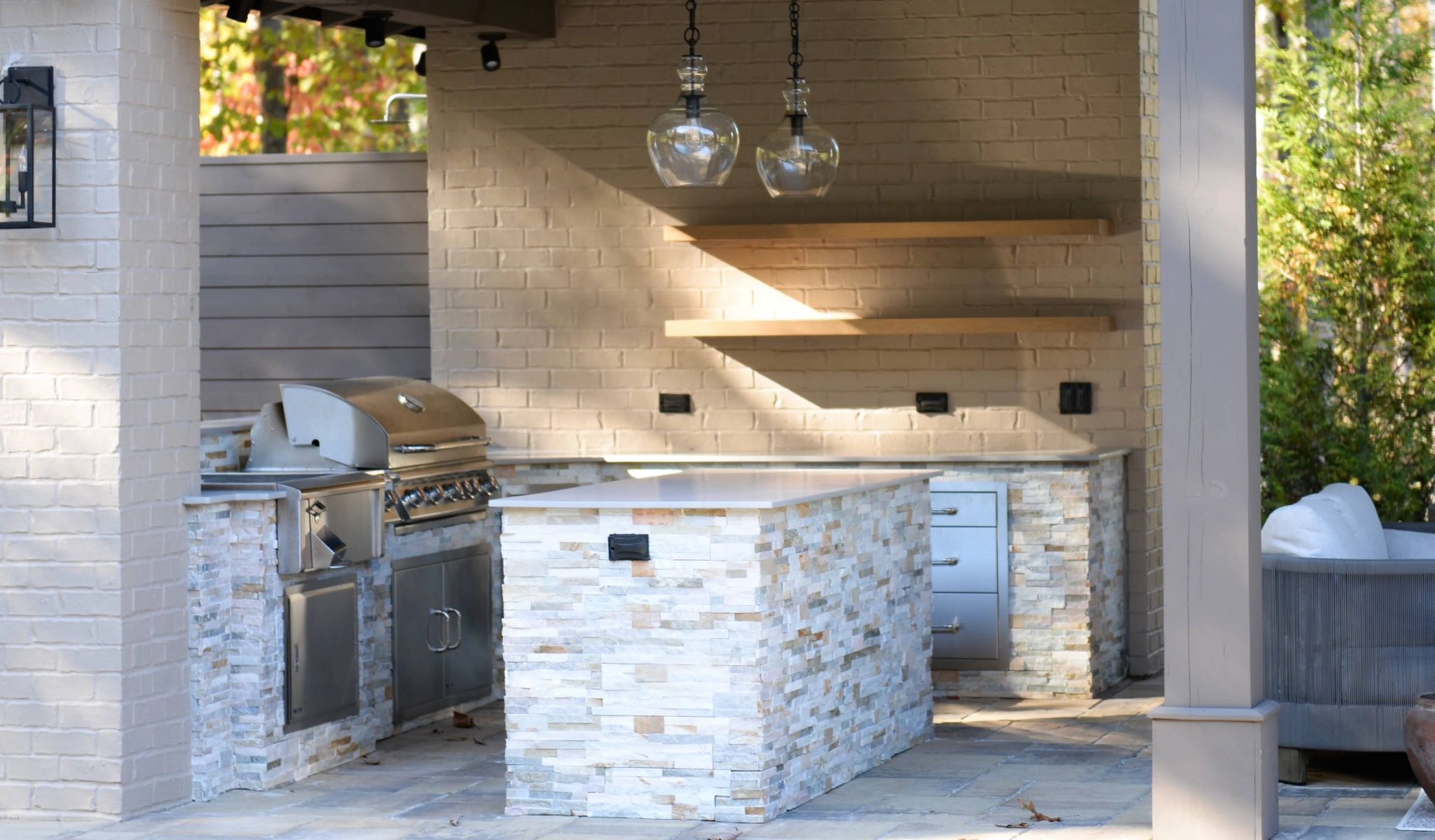 A custom-built outdoor kitchen with a grill.