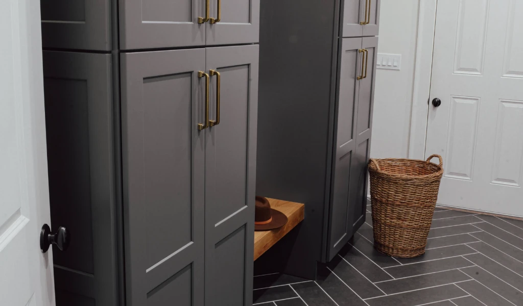 A gray mudroom with a basket on the floor.