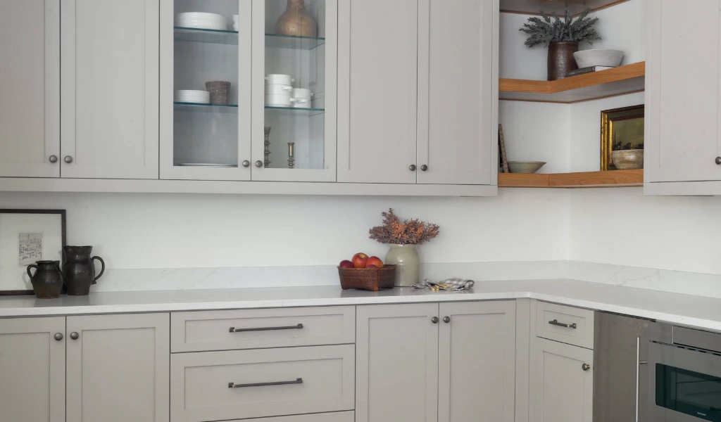 A kitchen with white cabinets and stainless steel appliances.