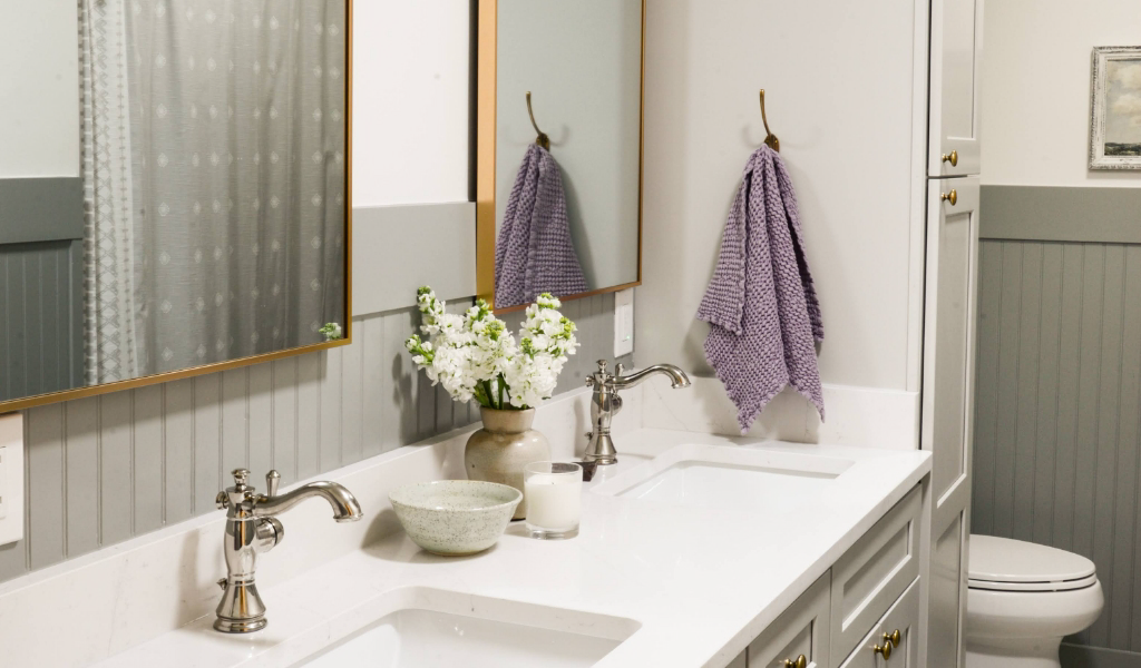 A bathroom with two sinks and two mirrors.