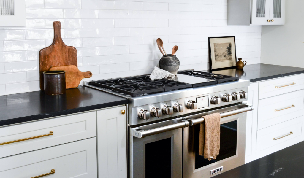 A black and white kitchen with a stove and oven in a new home construction.