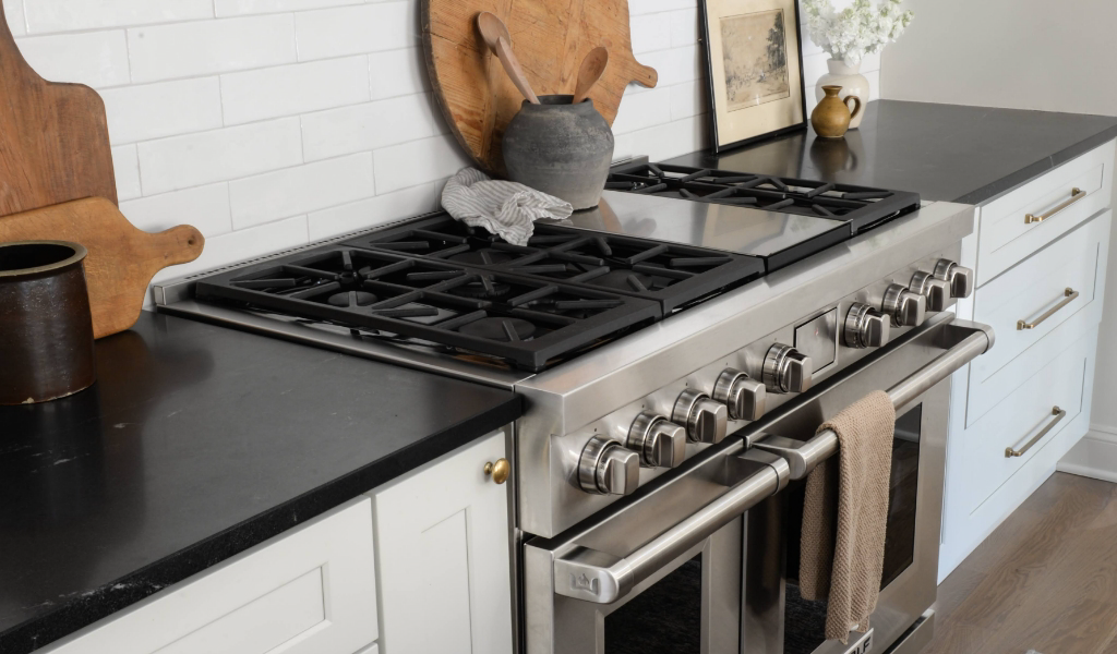 A black and white kitchen with a stainless steel stove.