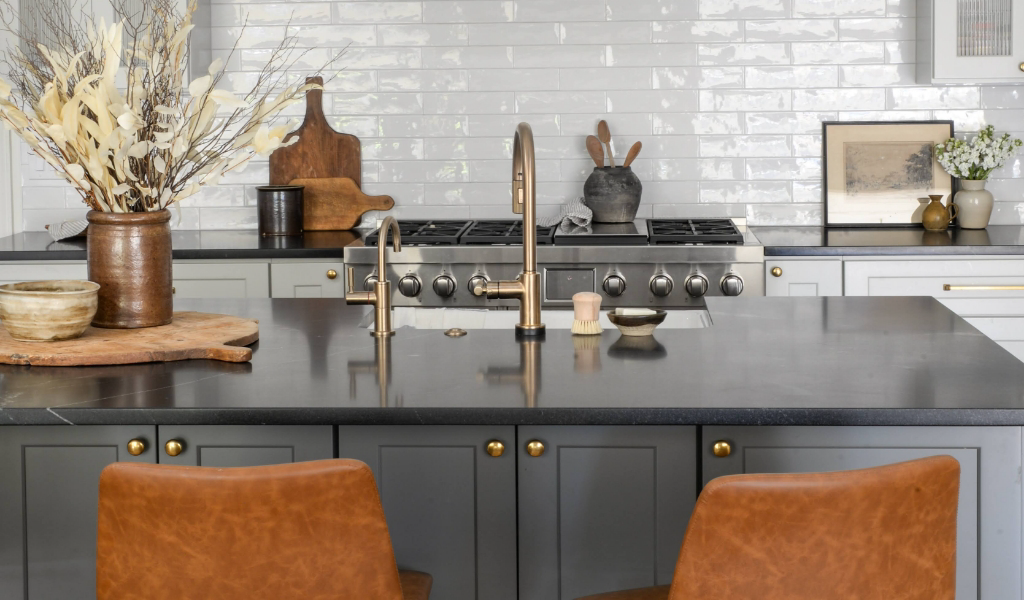 A kitchen with brown leather chairs and a marble countertop.